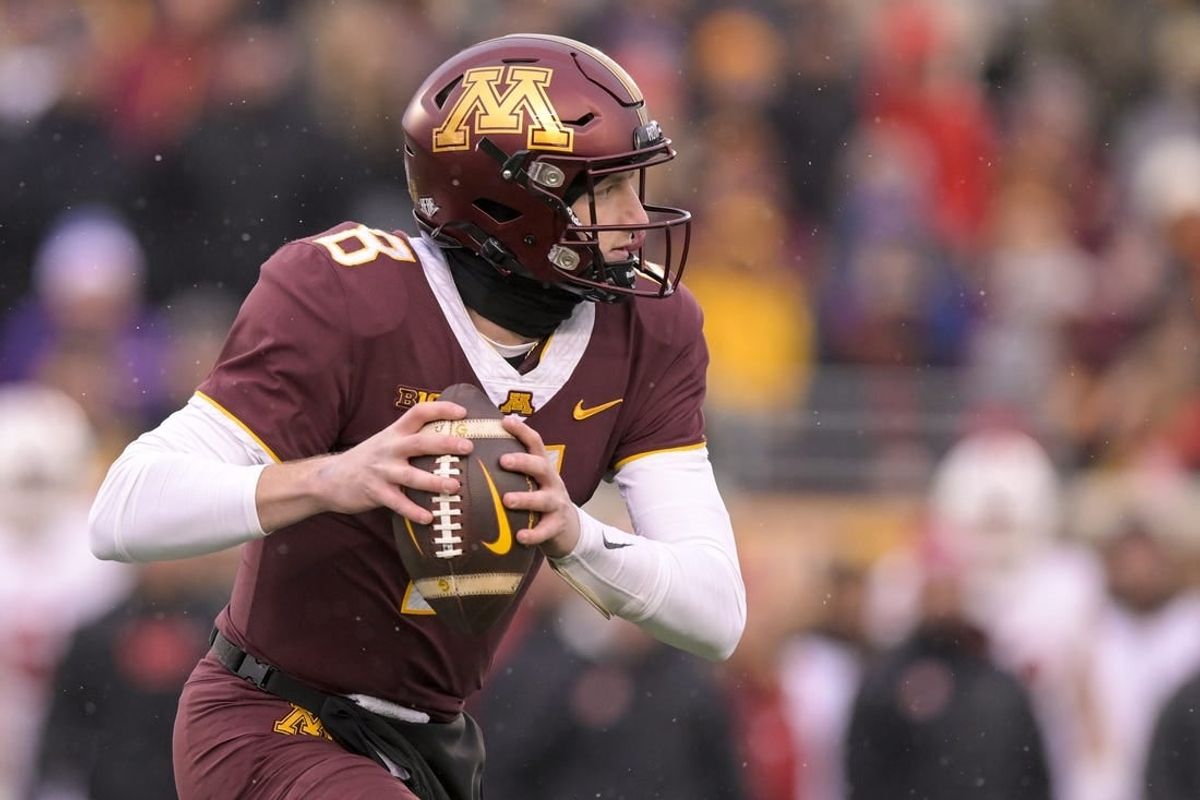 Nov 25, 2023; Minneapolis, Minnesota, USA;  Minnesota Golden Gophers quarterback Athan Kaliakmanis (8) scrambles out of the pocket against the Wisconsin Badgers during the second quarter at Huntington Bank Stadium.