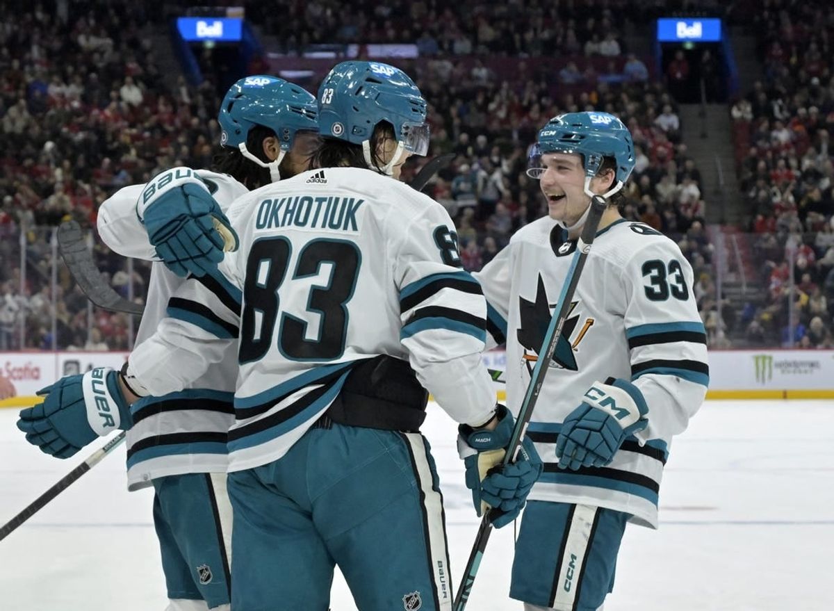 Jan 11, 2024; Montreal, Quebec, CAN; San Jose Sharks defenseman Nikita Okhotiuk (83) celebrates with teammates including defenseman Calen Addison (33) and forward Anthony Duclair (10) after scoring a goal against the Montreal Canadiens during the second period at the Bell Centre.