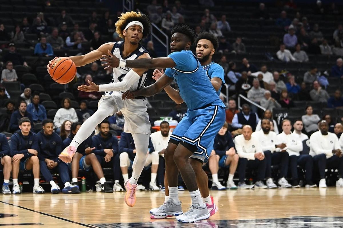 Jan 23, 2024; Washington, District of Columbia, USA; Butler Bulldogs guard DJ Davis (4) passes around Georgetown Hoyas guard Jay Heath (5) during the first half at Capital One Arena.