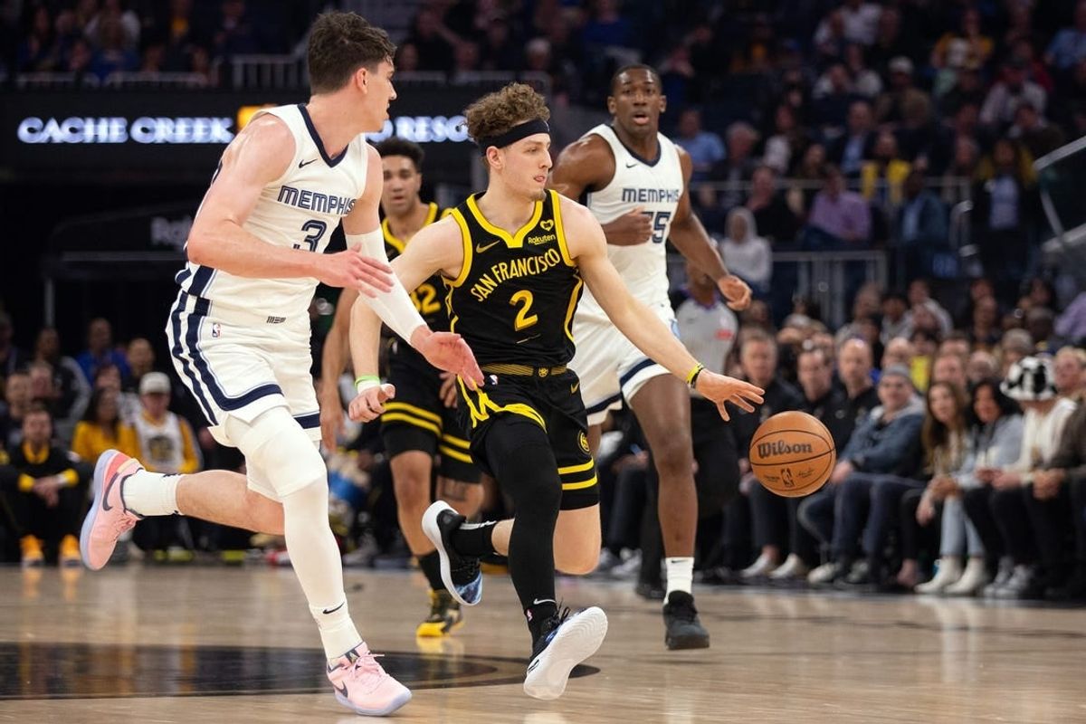 Mar 20, 2024; San Francisco, California, USA; Golden State Warriors guard Brandin Podziemski (2) drives between Memphis Grizzlies forward Jake LaRavia (3) and center Trey Jemison (55) during the first quarter at Chase Center.