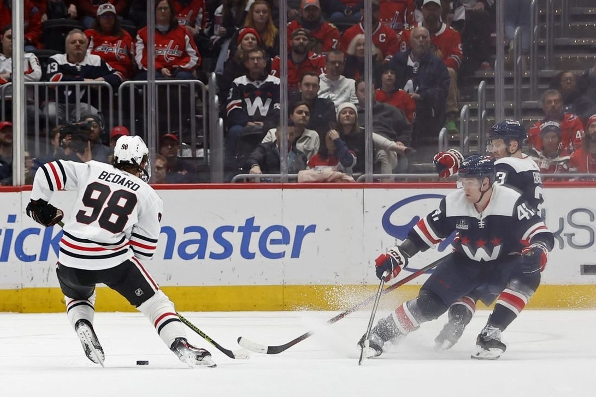 Mar 9, 2024; Washington, District of Columbia, USA; Chicago Blackhawks center Connor Bedard (98) skates with the puck as Washington Capitals left wing Beck Malenstyn (47) and Capitals defenseman Nick Jensen (3) defend in the third period at Capital One Arena.