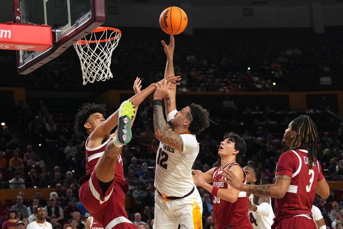 Feb 1, 2024; Tempe, Arizona, USA; Arizona State Sun Devils guard Jose Perez (12) shoots over Stanford Cardinal forward Spencer Jones (14) during the second half at Desert Financial Arena.