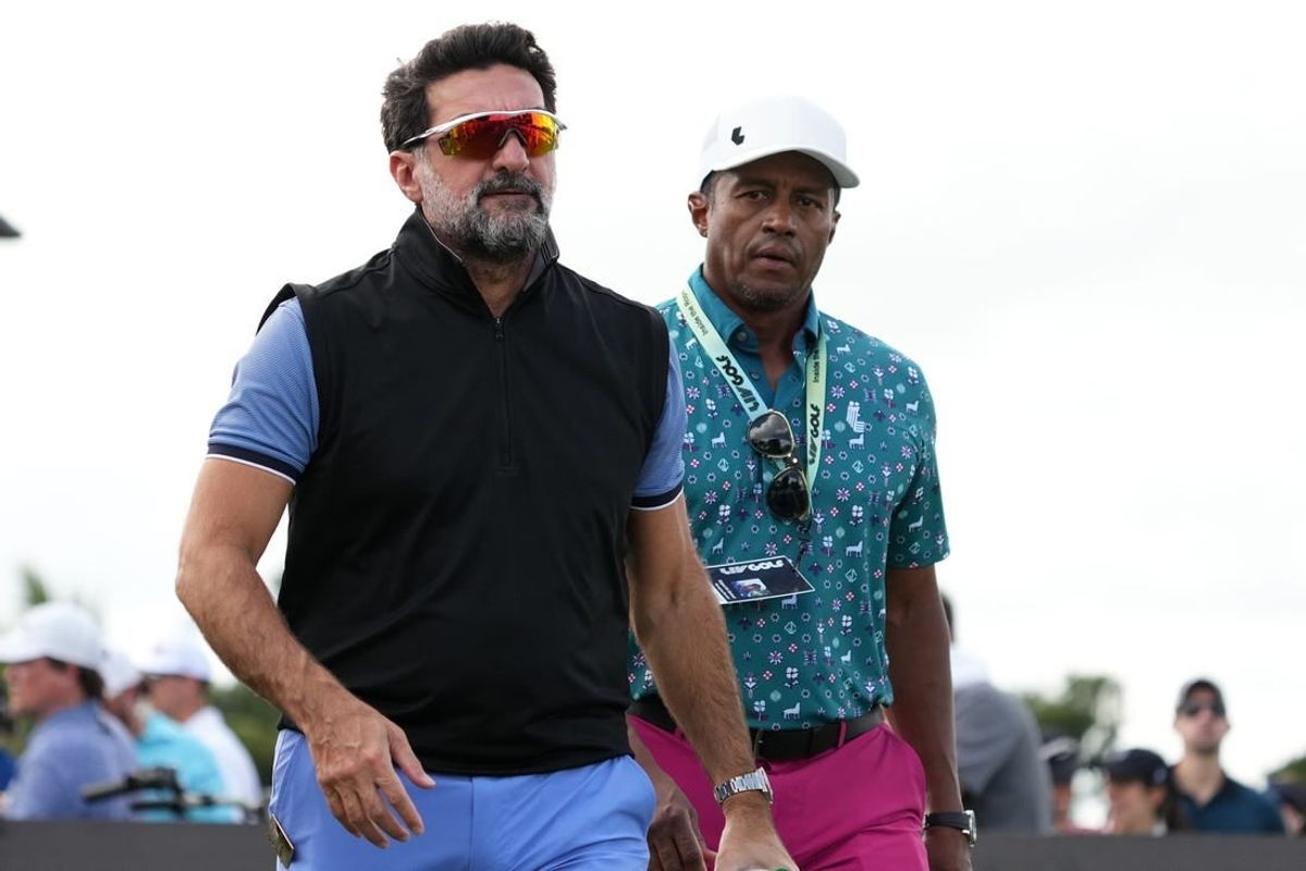 Oct 29, 2022; Miami, Florida, USA; Yasir Al-Rumayyan (L) walks next to Saudi golf CEO Majed Al Surour (R) during the second round of the season finale of the LIV Golf series at Trump National Doral.