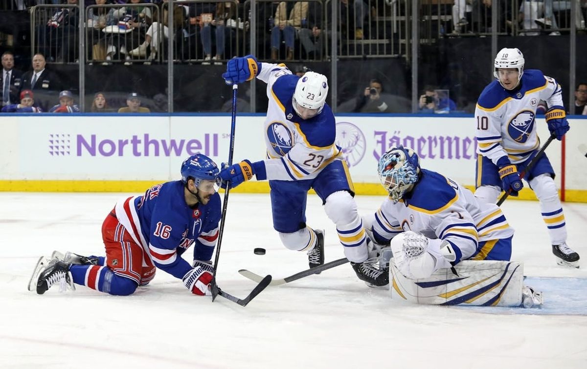 Nov 27, 2023; New York, New York, USA; Buffalo Sabres goalie Ukko-Pekka Luukkonen (1) makes a save as New York Rangers center Vincent Trocheck (16) and Buffalo Sabres defenseman Mattias Samuelsson (23) battle for the puck during the second period at Madison Square Garden.