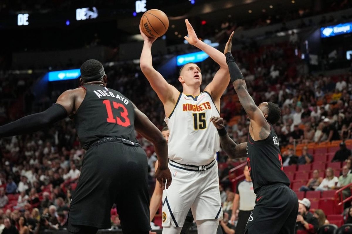 Mar 13, 2024; Miami, Florida, USA;  Denver Nuggets center Nikola Jokic (15) takes a shot over Miami Heat guard Terry Rozier (2) during the first half at Kaseya Center.