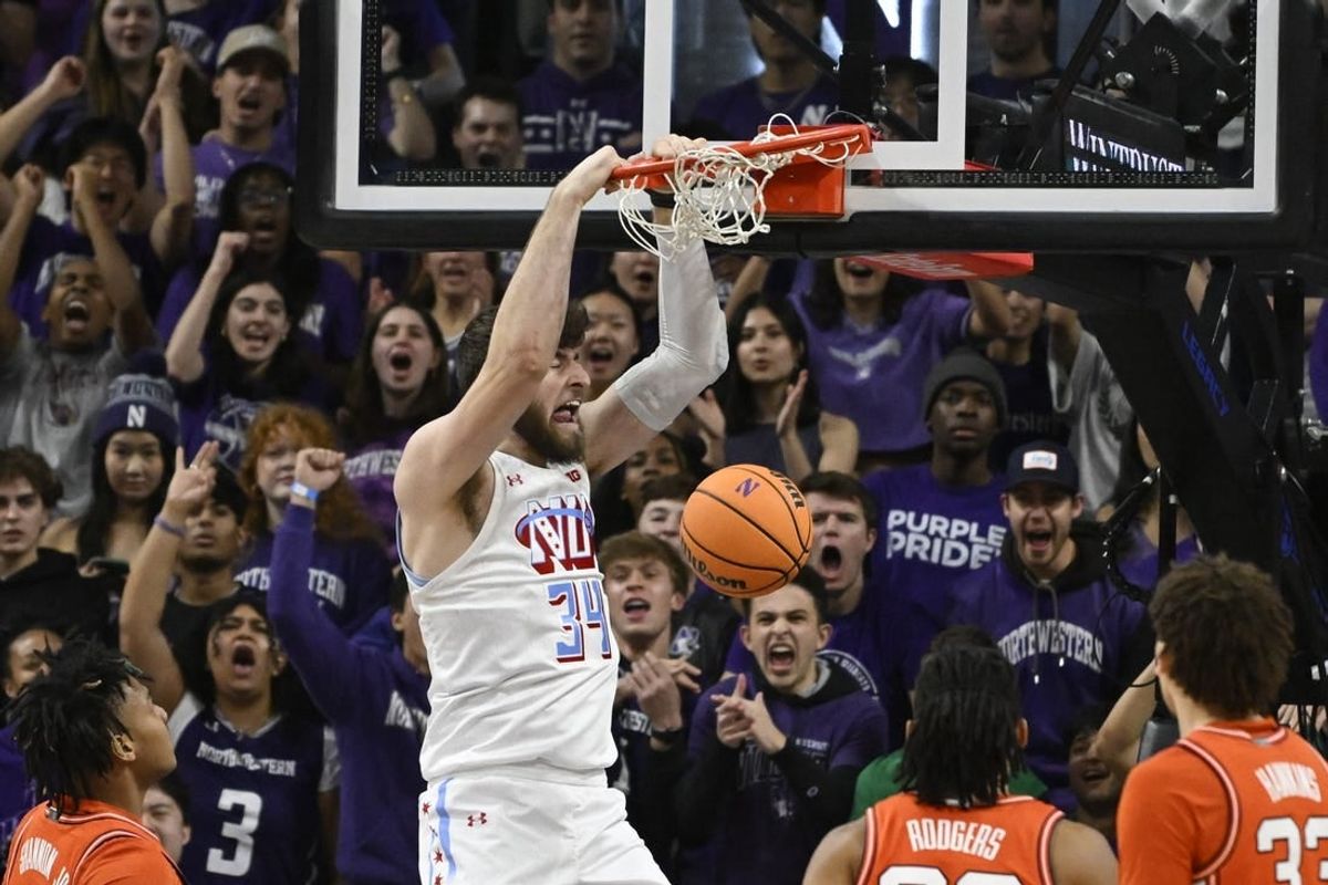 Jan 24, 2024; Evanston, Illinois, USA;  Northwestern Wildcats center Matthew Nicholson (34) dunks the ball against the Illinois Fighting Illini during the first half at Welsh-Ryan Arena.