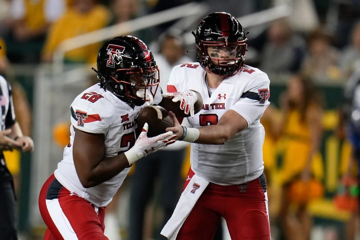 Oct 7, 2023; Waco, Texas, USA; Texas Tech Red Raiders quarterback Behren Morton (2) hands the ball off to Texas Tech Red Raiders running back Tahj Brooks (28) against the Baylor Bears during the second half at McLane Stadium.