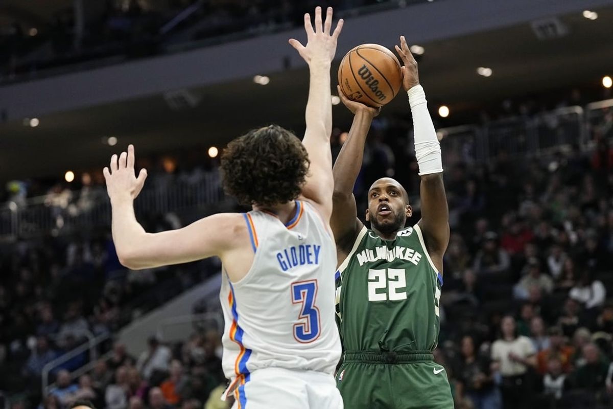 Mar 24, 2024; Milwaukee, Wisconsin, USA;  Milwaukee Bucks forward Khris Middleton (22) shoots against Oklahoma City Thunder guard Josh Giddey (3) during the third quarter at Fiserv Forum.
