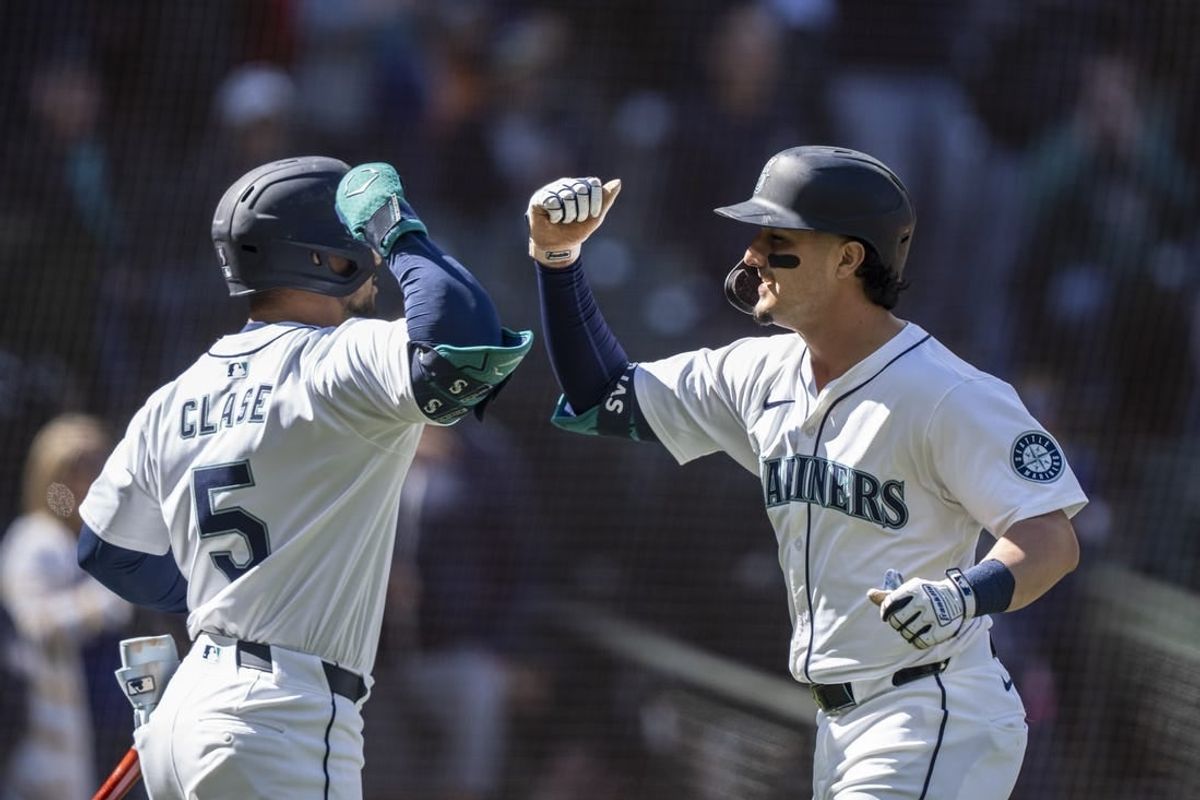 Apr 17, 2024; Seattle, Washington, USA; Seattle Mariners third baseman Josh Rojas (4) celebrates with left fielder Jonatan Clase (5) after hitting a solo home run during the seventh inning against the Cincinnati Reds at T-Mobile Park.