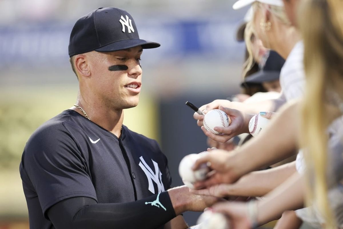Mar 1, 2024; Tampa, Florida, USA; New York Yankees center fielder Aaron Judge (99) signs autographs before a game against the Toronto Blue Jays at George M. Steinbrenner Field.