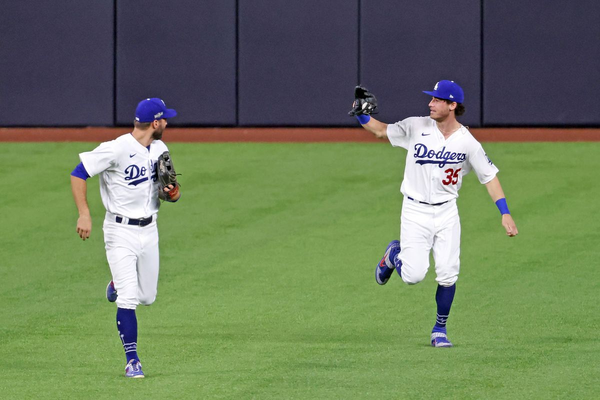 Cody Bellinger shows off ball he caught over the wall that robbed San Diego’s Fernando Tatis of a home run.