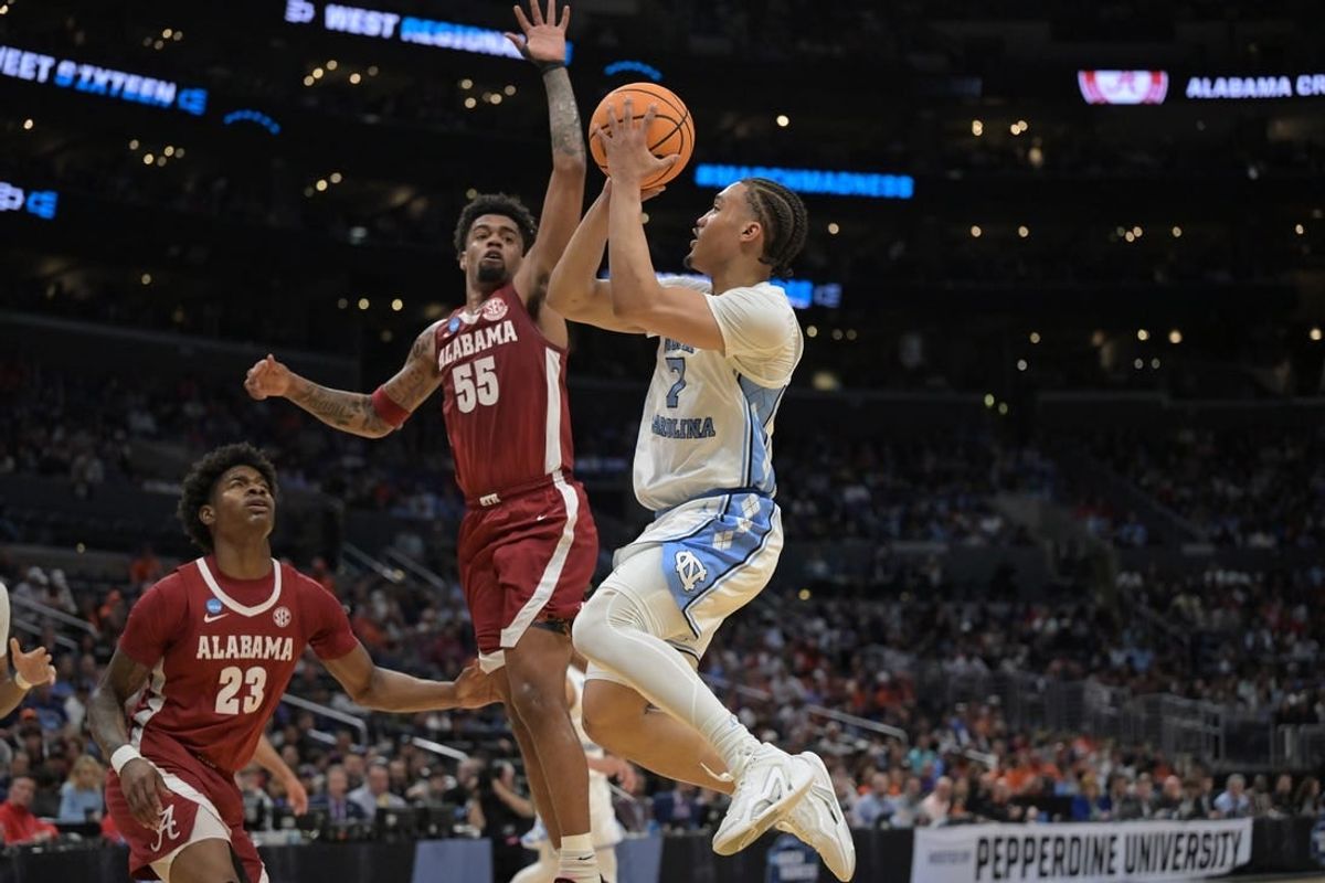 Mar 28, 2024; Los Angeles, CA, USA; North Carolina Tar Heels guard Seth Trimble (7) shoots against Alabama Crimson Tide guard Aaron Estrada (55) in the first half in the semifinals of the West Regional of the 2024 NCAA Tournament at Crypto.com Arena.