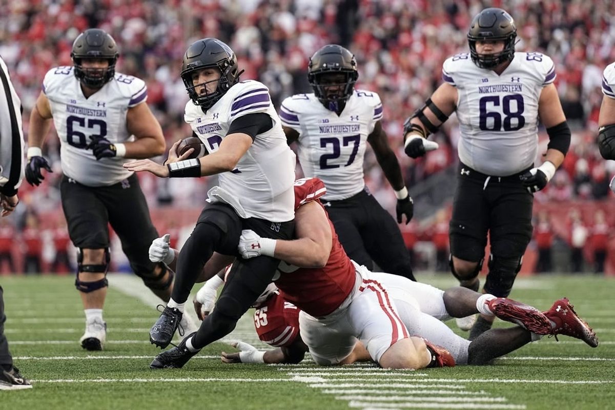 Nov 11, 2023; Madison, Wisconsin, USA;  Northwestern Wildcats quarterback Ben Bryant (2) rushes with the football during the second quarter against the Wisconsin Badgers at Camp Randall Stadium.