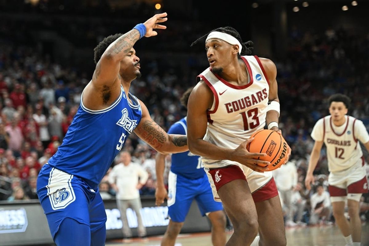 Mar 21, 2024; Omaha, NE, USA; Washington State Cougars guard Isaiah Watts (12) controls the ball against Drake Bulldogs forward Darnell Brodie (51) in the first half in the first round of the 2024 NCAA Tournament at CHI Health Center Omaha.