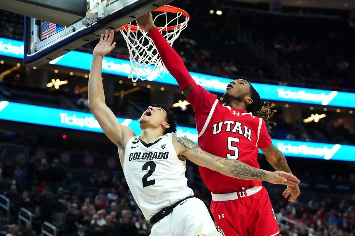 Mar 14, 2024; Las Vegas, NV, USA; Colorado Buffaloes guard KJ Simpson (2) shoots underneath Utah Utes guard Deivon Smith (5) during the first half at T-Mobile Arena.