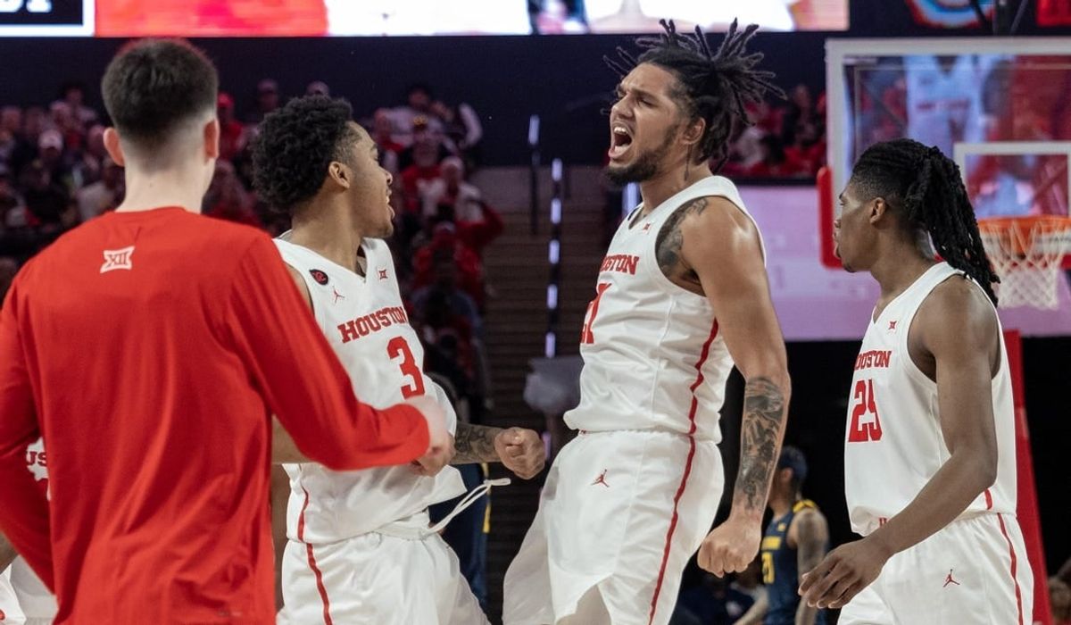 Jan 6, 2024; Houston, Texas, USA;Houston Cougars guard Emanuel Sharp (21) celebrates with guard Ramon Walker Jr. (3) against the West Virginia Mountaineers  in the first half  at Fertitta Center.