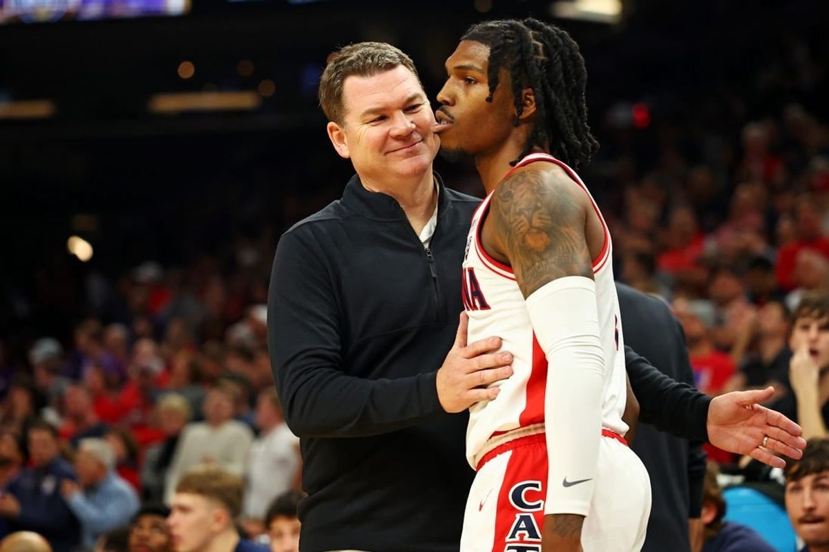 Dec 20, 2023; Phoenix, Arizona, USA; Arizona Wildcats head coach Tommy Lloyd talks to guard Caleb Love (2) during the second half of the game against the Alabama Crimson Tide in the Hall of Fame Series at Footprint Center.