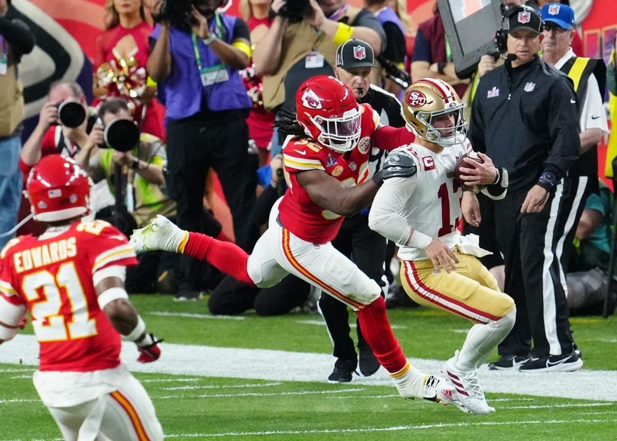 Feb 11, 2024; Paradise, Nevada, USA; San Francisco 49ers quarterback Brock Purdy (13) is tackled by Kansas City Chiefs linebacker Nick Bolton (32) in the first half in Super Bowl LVIII at Allegiant Stadium.