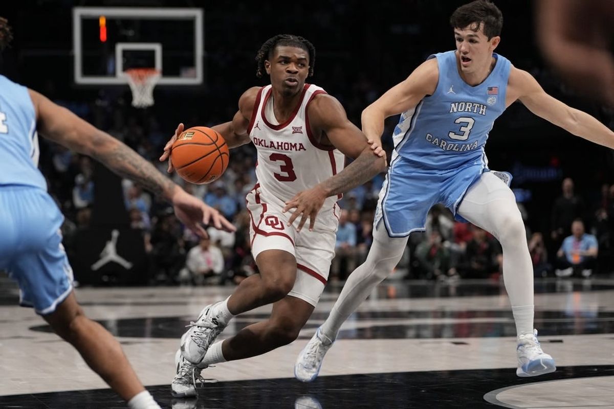 Dec 20, 2023; Charlotte, North Carolina, USA; Oklahoma Sooners guard Otega Oweh (3) drives to the basket against North Carolina Tar Heels guard Cormac Ryan (3) during the first half at Spectrum Center.