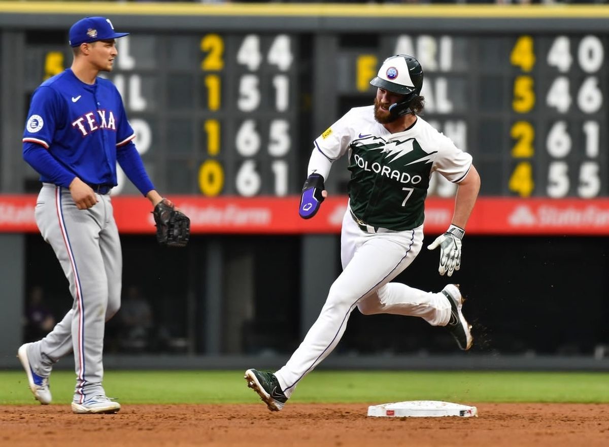 May 11, 2024; Denver, Colorado, USA; Colorado Rockies second base Brendan Rodgers (7) rounds second base against the Texas Rangers during the third inning at Coors Field.