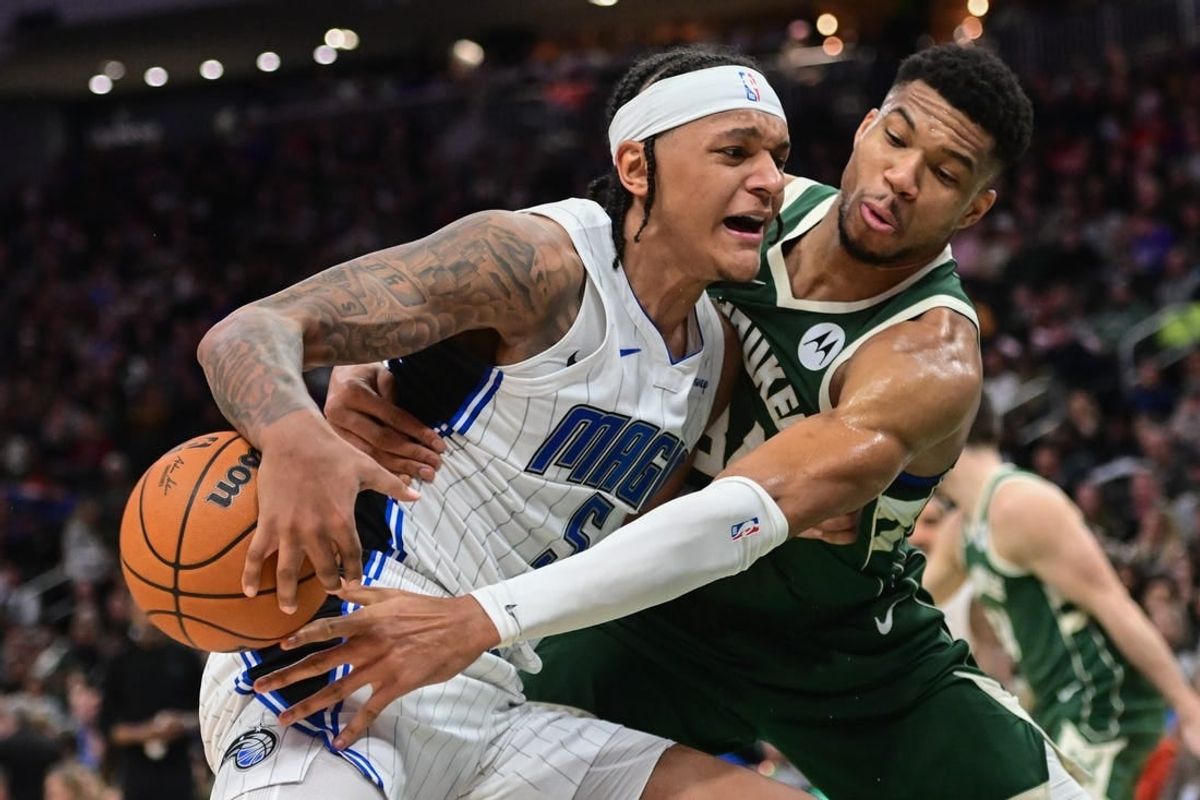 Dec 21, 2023; Milwaukee, Wisconsin, USA; Milwaukee Bucks forward Giannis Antetokounmpo (34) tries to steal the ball from Orlando Magic forward Paolo Banchero (5) in the third quarter at Fiserv Forum.