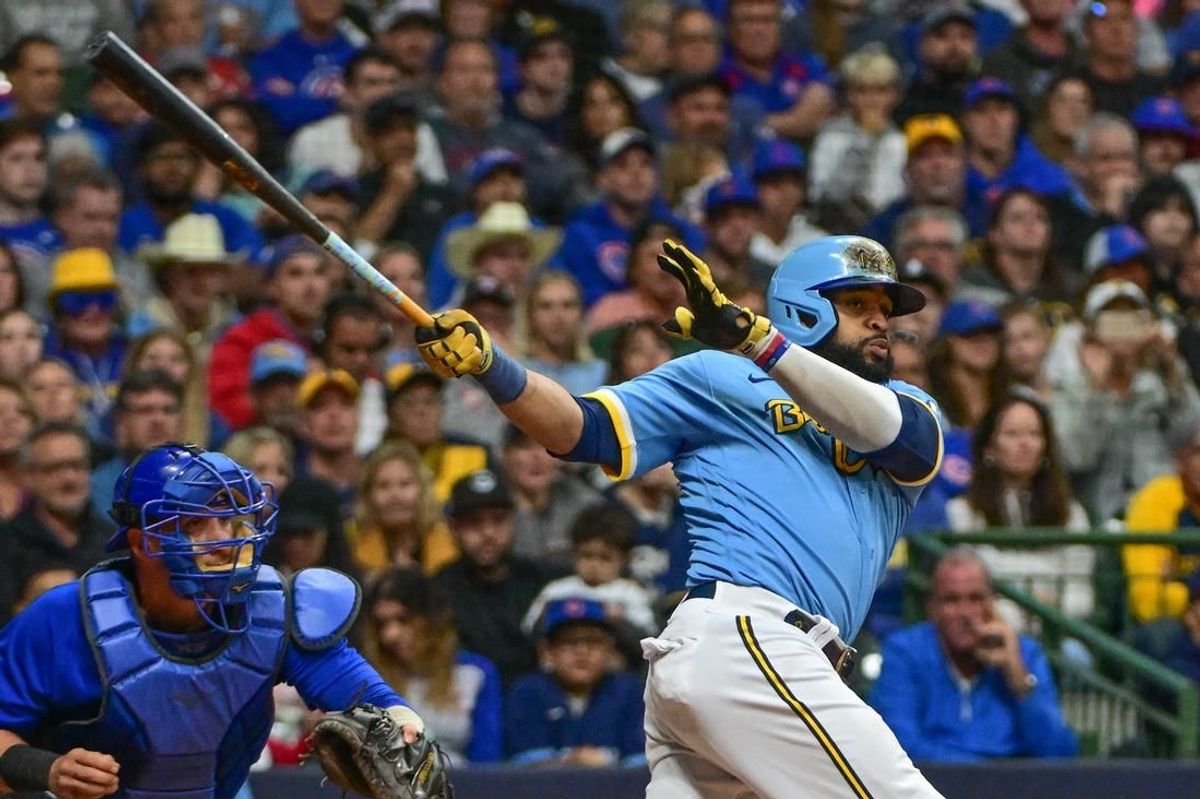 Sep 29, 2023; Milwaukee, Wisconsin, USA;  Milwaukee Brewers first baseman Carlos Santana (41) hits a RBI triple against the Chicago Cubs in the fifth inning at American Family Field.