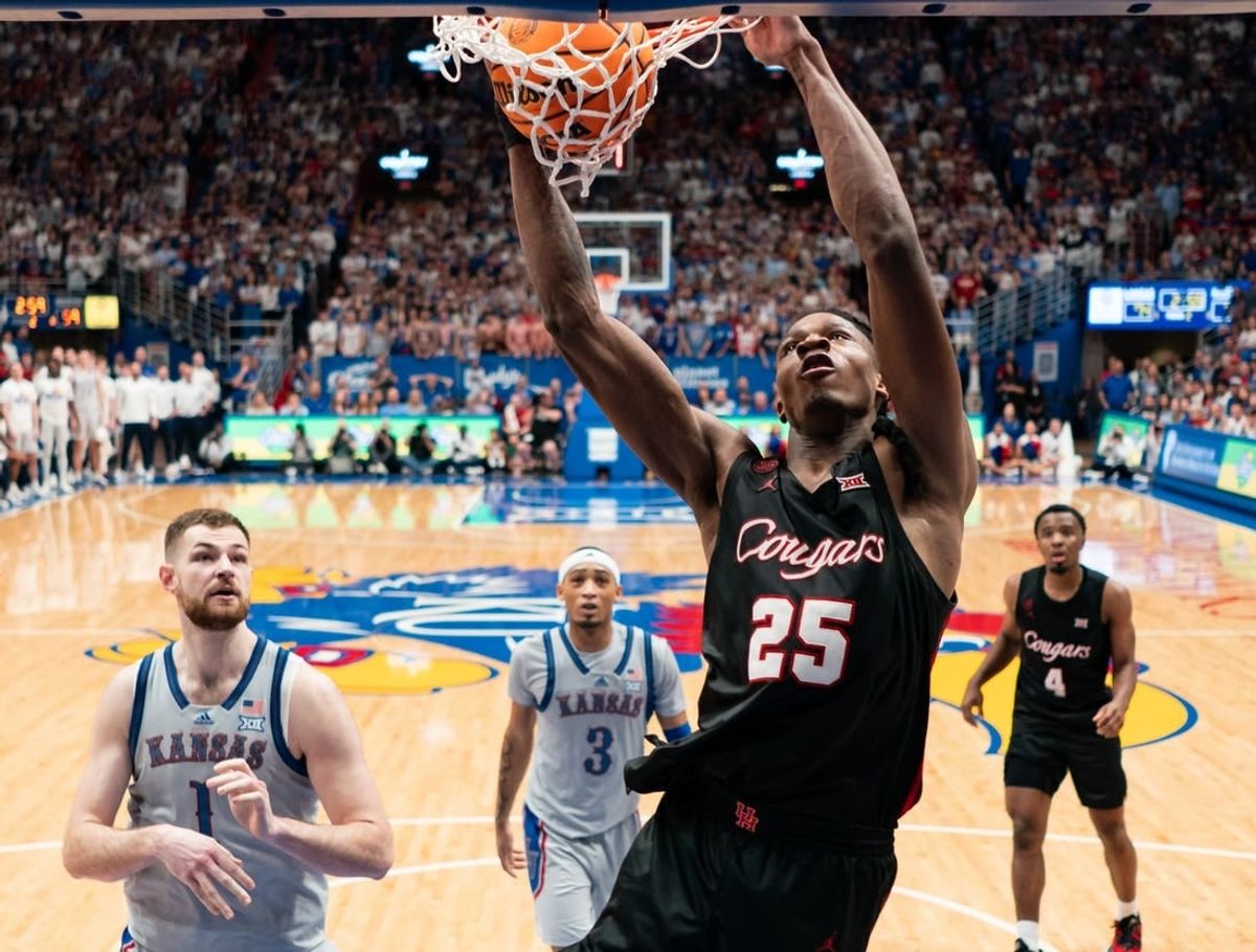 Feb 3, 2024; Lawrence, Kansas, USA; Houston Cougars forward Joseph Tugler (25) dunks the ball against the Kansas Jayhawks during the second half at Allen Fieldhouse.