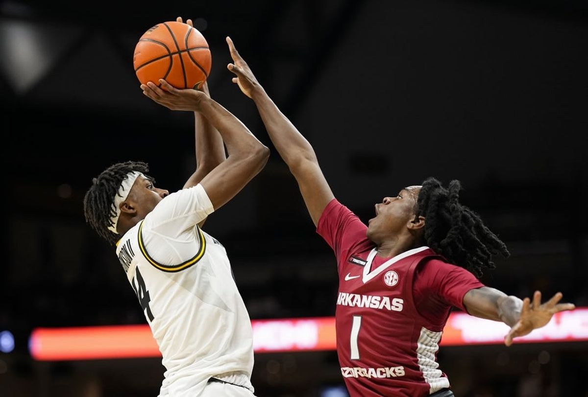 Jan 31, 2024; Columbia, Missouri, USA; Missouri Tigers guard Anthony Robinson II (14) shoots against Arkansas Razorbacks guard Keyon Menifield Jr. (1) during the first half at Mizzou Arena.