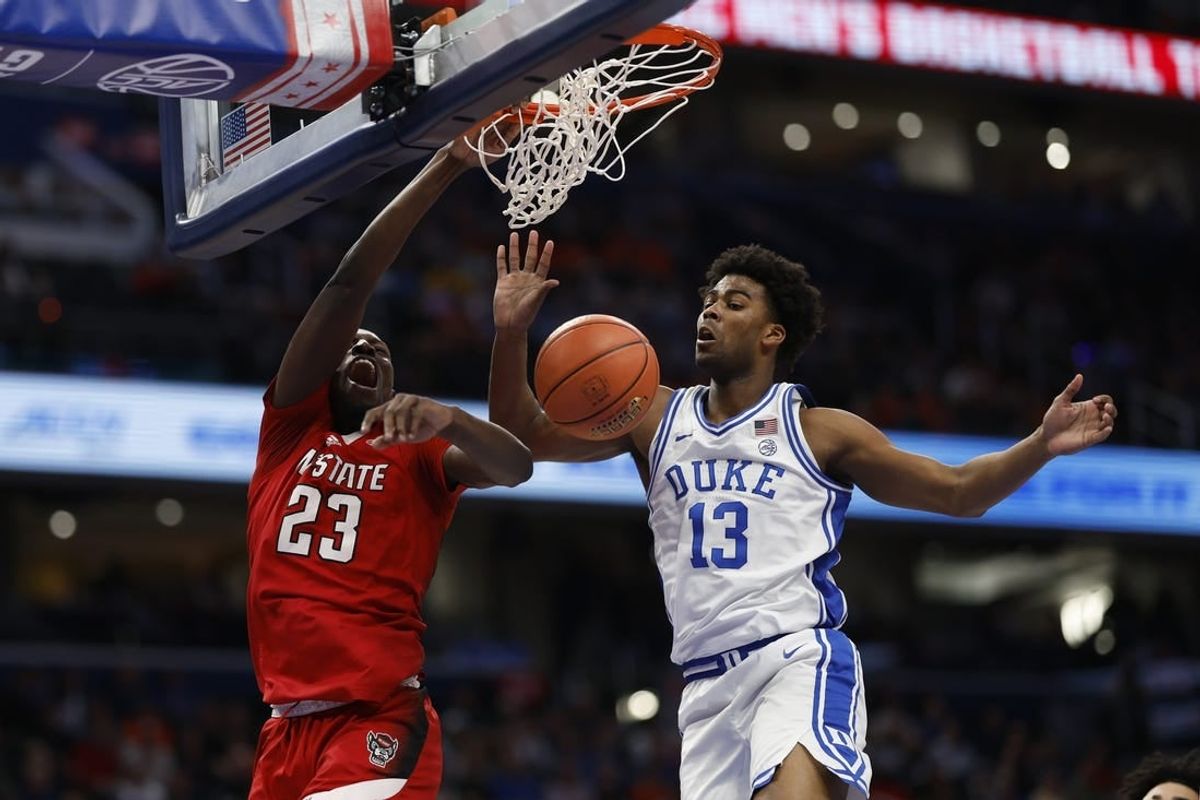 Mar 14, 2024; Washington, D.C., USA; North Carolina State forward Mohamed Diarra (23) dunks the ball as Duke Blue Devils forward Sean Stewart (13) defends in the first half at Capital One Arena.
