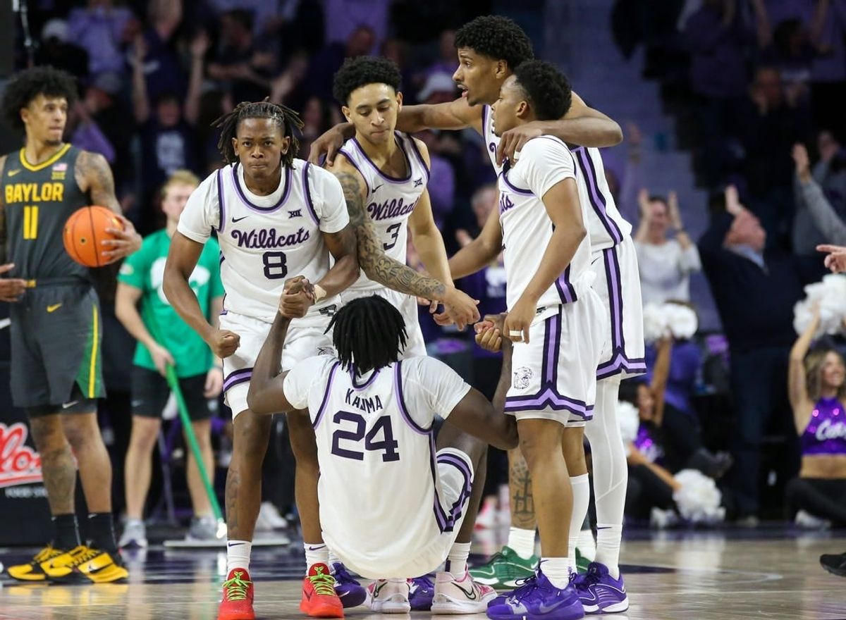 Jan 16, 2024; Manhattan, Kansas, USA; Kansas State Wildcats forward Arthur Kaluma (24) is helped off the floor by teammates after hitting the game-winning three-point basket in overtime against the Baylor Bears at Bramlage Coliseum.