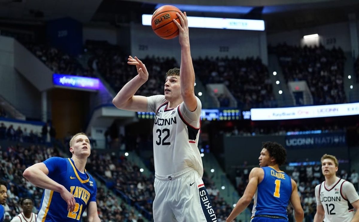 Jan 28, 2024; Hartford, Connecticut, USA; UConn Huskies center Donovan Clingan (32) makes the basket against the Xavier Musketeers in the second half at XL Center.