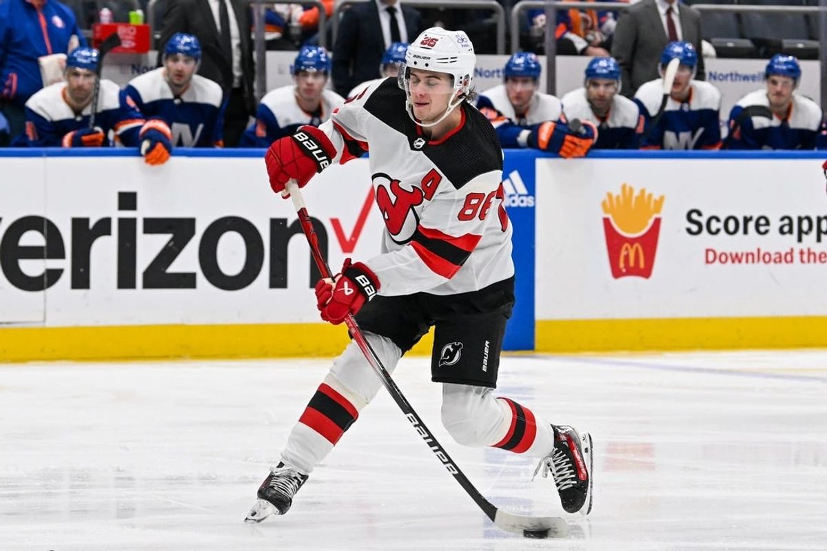 Mar 24, 2024; Elmont, New York, USA; New Jersey Devils center Jack Hughes (86) attempts a shot against the New York Islanders during the third period at UBS Arena.