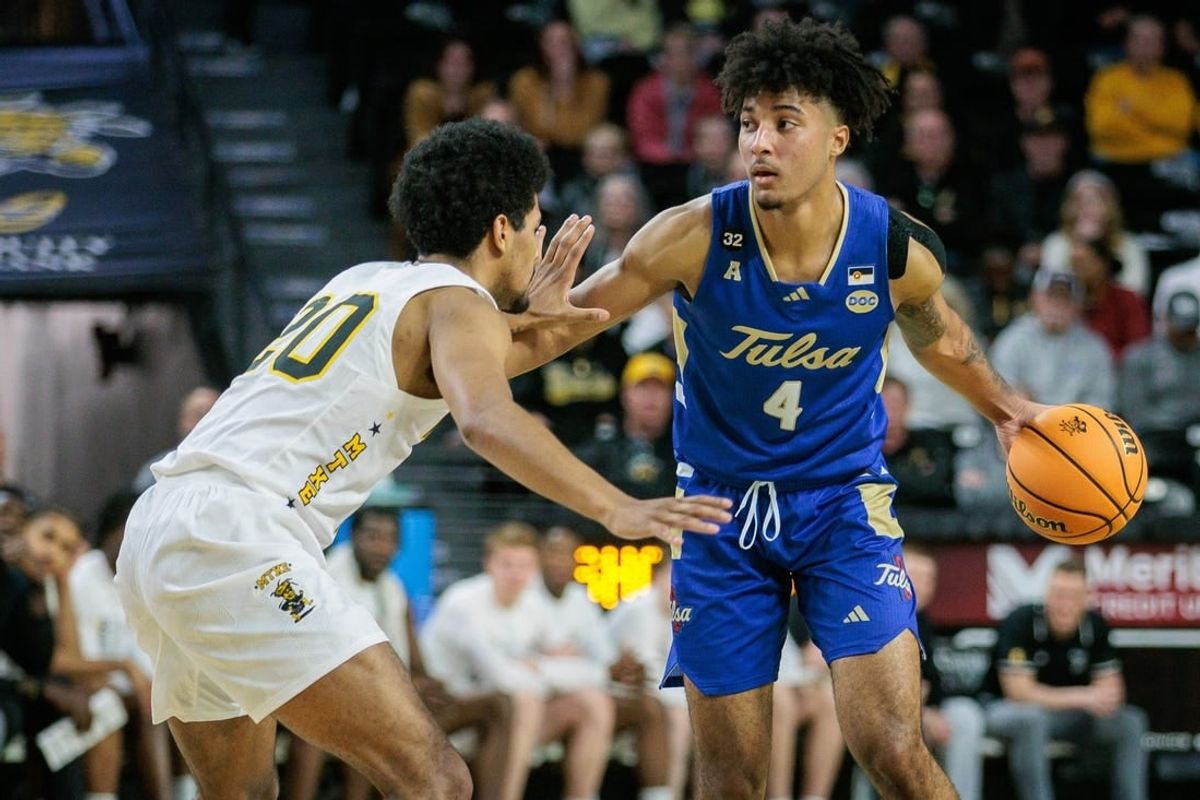 Feb 21, 2024; Wichita, Kansas, USA; Tulsa Golden Hurricane guard PJ Haggerty (4) brings the ball up court around Wichita State Shockers guard Harlond Beverly (20) during the second half at Charles Koch Arena.