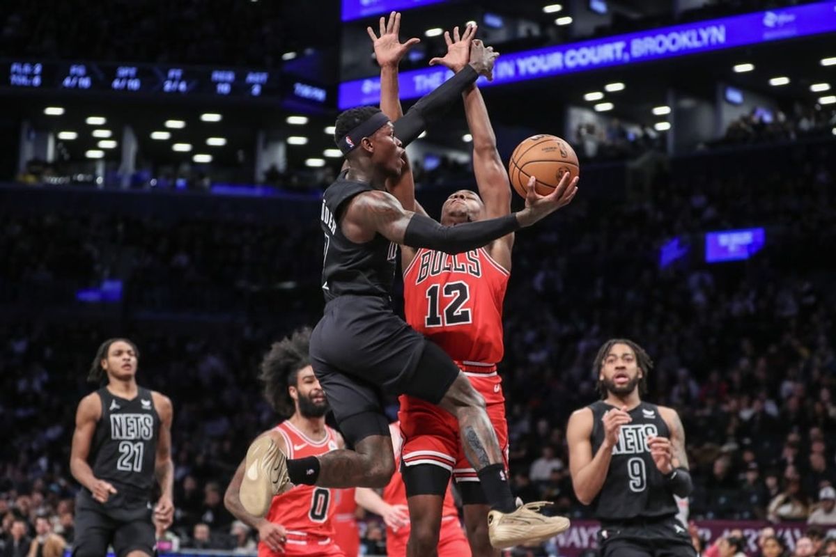 Mar 29, 2024; Brooklyn, New York, USA; Brooklyn Nets guard Dennis Schroder (17) drives past Chicago Bulls guard Ayo Dosunmu (12) in the first quarter at Barclays Center.
