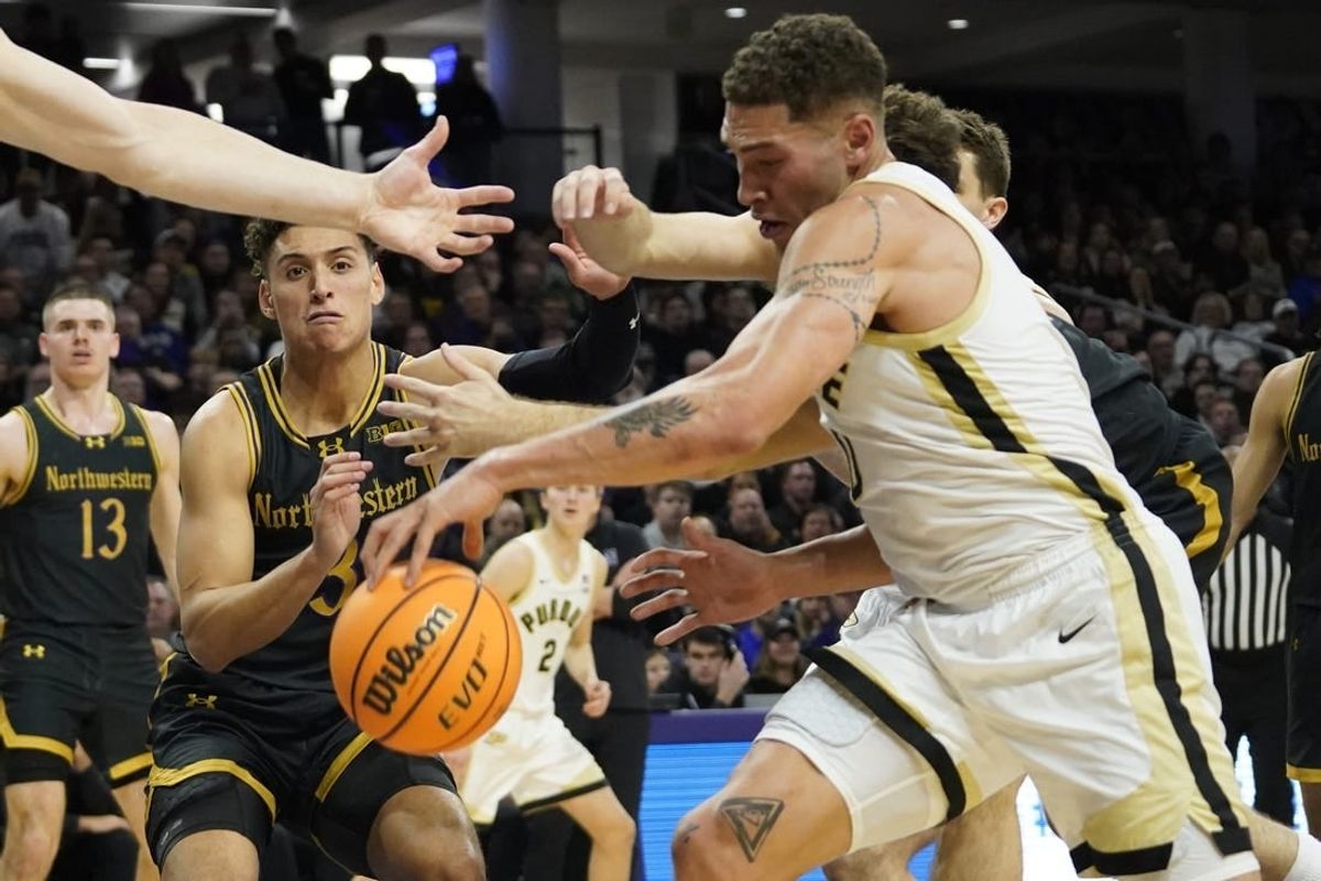 Dec 1, 2023; Evanston, Illinois, USA; Northwestern Wildcats guard Ty Berry (3) and Purdue Boilermakers forward Mason Gillis (0) go for a loose ball during the first half at Welsh-Ryan Arena.