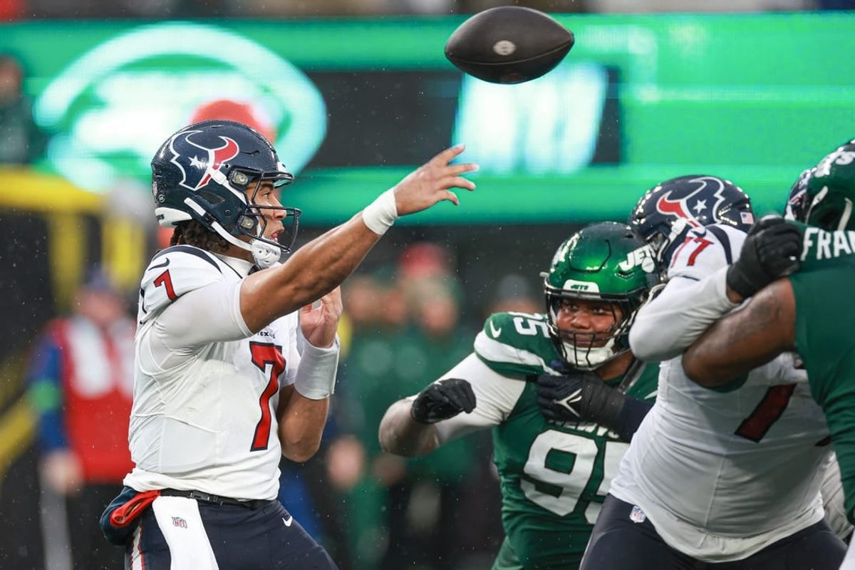 Dec 10, 2023; East Rutherford, New Jersey, USA; Houston Texans quarterback C.J. Stroud (7) throws the ball asNew York Jets defensive tackle Quinnen Williams (95) pursues during the second half at MetLife Stadium.  Stroud was injured on the play and left the game.