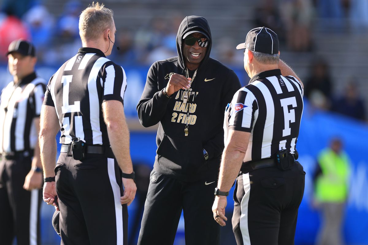 Deion Sanders chatting with the officials on his way to Sportsperson of the Year honors.