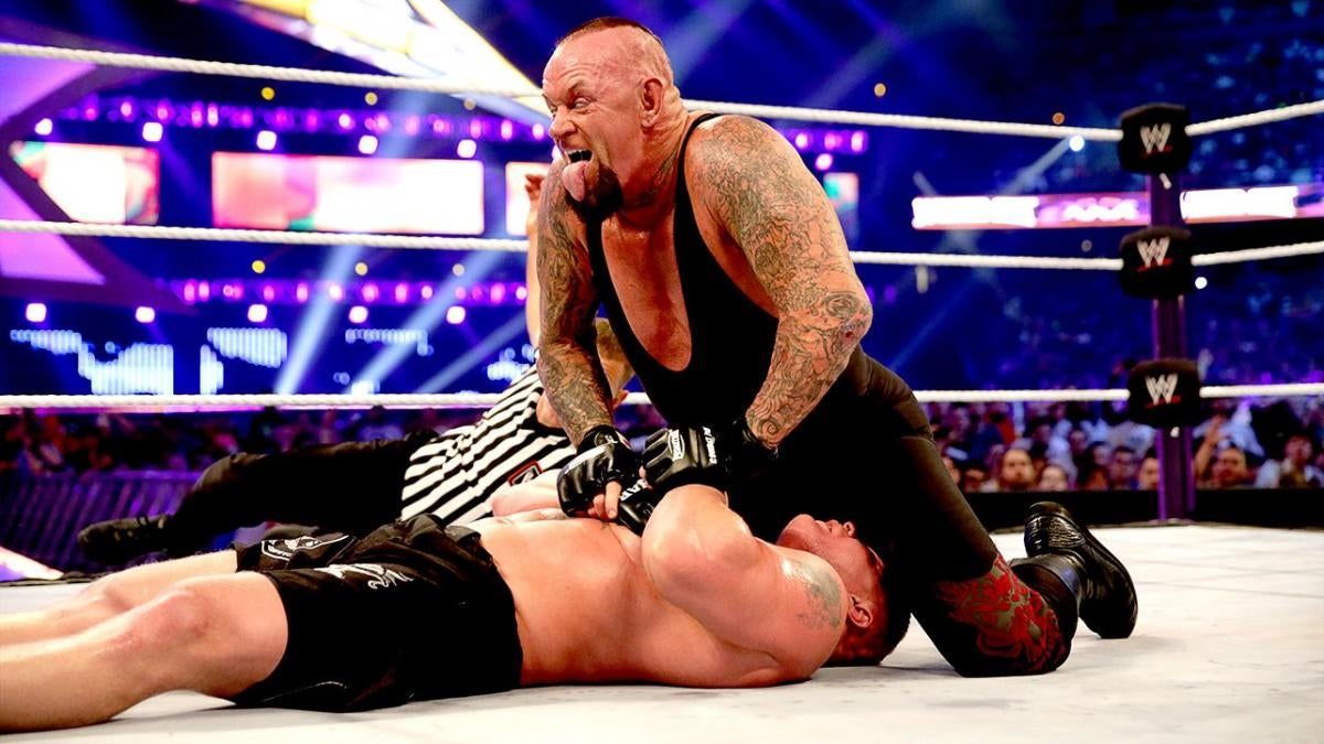 The Undertaker covers Brock Lesnar after a tombstone piledriver at WrestleMania XXX in New Orleans.