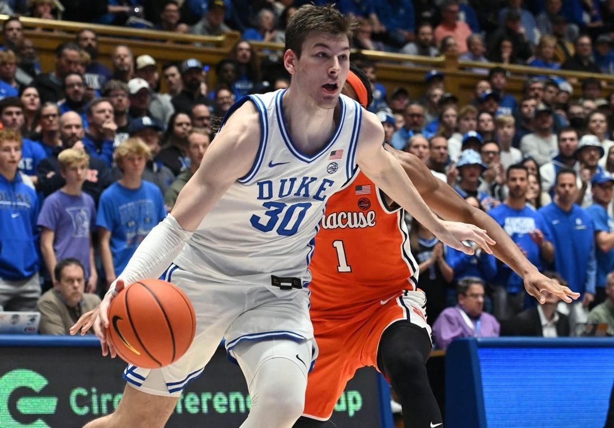 Jan 2, 2024; Durham, North Carolina, USA;  Duke Blue Devils center Kyle Filipowski (30) drives to the basket as Syracuse Orange forward Maliq Brown (1) defends during the second half at Cameron Indoor Stadium.  The Blue Devils won 86-66.