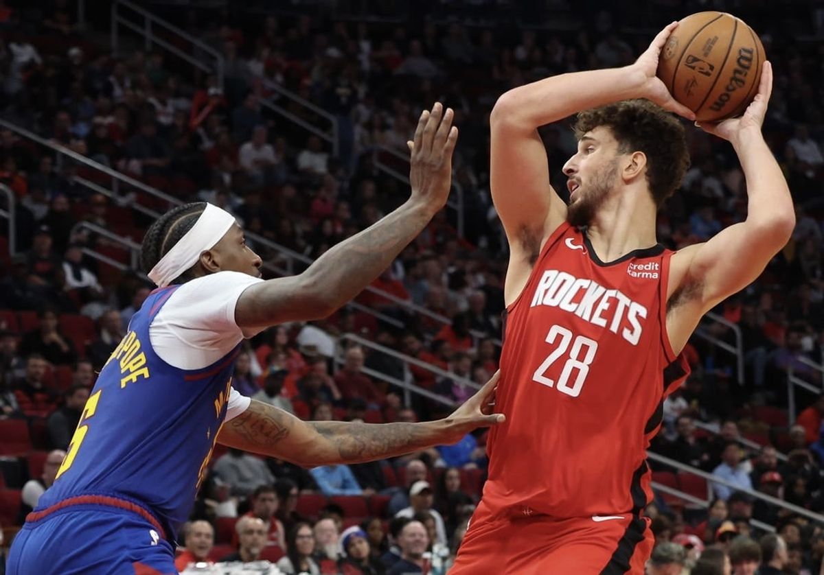Nov 12, 2023; Houston, Texas, USA; Houston Rockets center Alperen Sengun (28) looks to pass against Denver Nuggets guard Kentavious Caldwell-Pope (5) in the second quarter at Toyota Center.