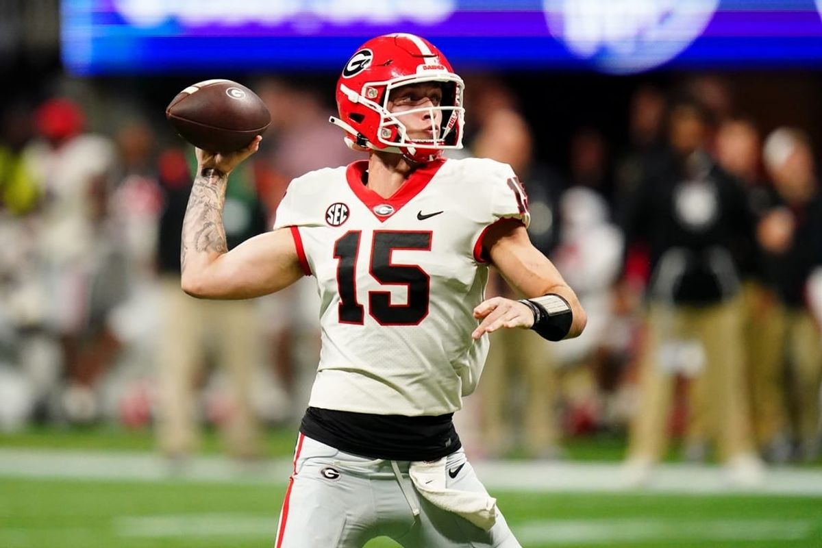 Dec 2, 2023; Atlanta, GA, USA;  Georgia Bulldogs quarterback Carson Beck (15) throws a pass against the Alabama Crimson Tide in the third quarter of the SEC Championship at Mercedes-Benz Stadium.