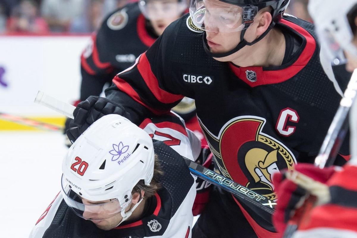 Dec 29, 2023; Ottawa, Ontario, CAN; New Jersey Devils center Michael McLeod (20) faces off against Ottawa Senators left wing Brady Tkachuk (7) in the first period at the Canadian Tire Centre.