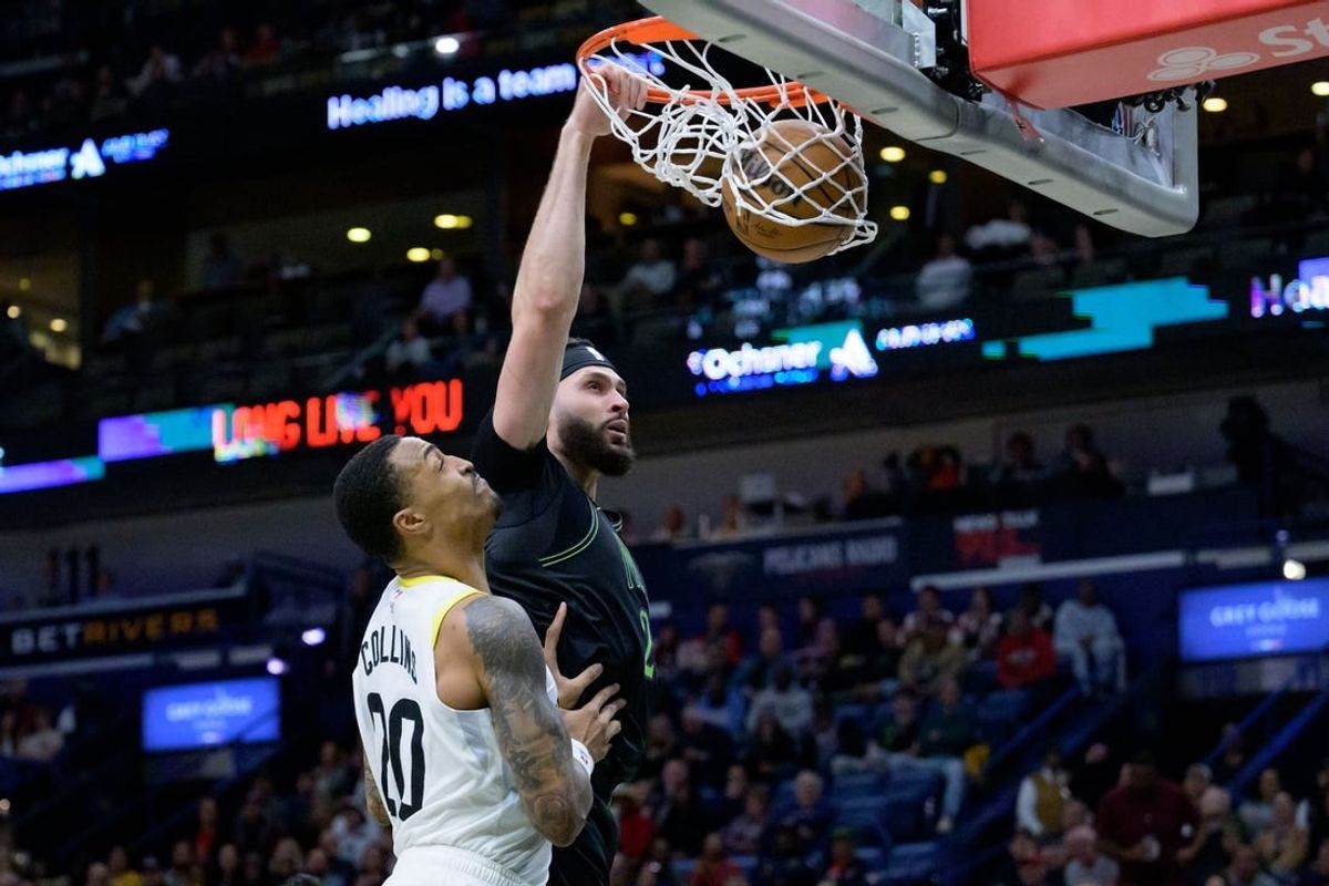Jan 23, 2024; New Orleans, Louisiana, USA;  New Orleans Pelicans forward Larry Nance Jr. (22) dunks against Utah Jazz forward John Collins (20) during the first half at Smoothie King Center.