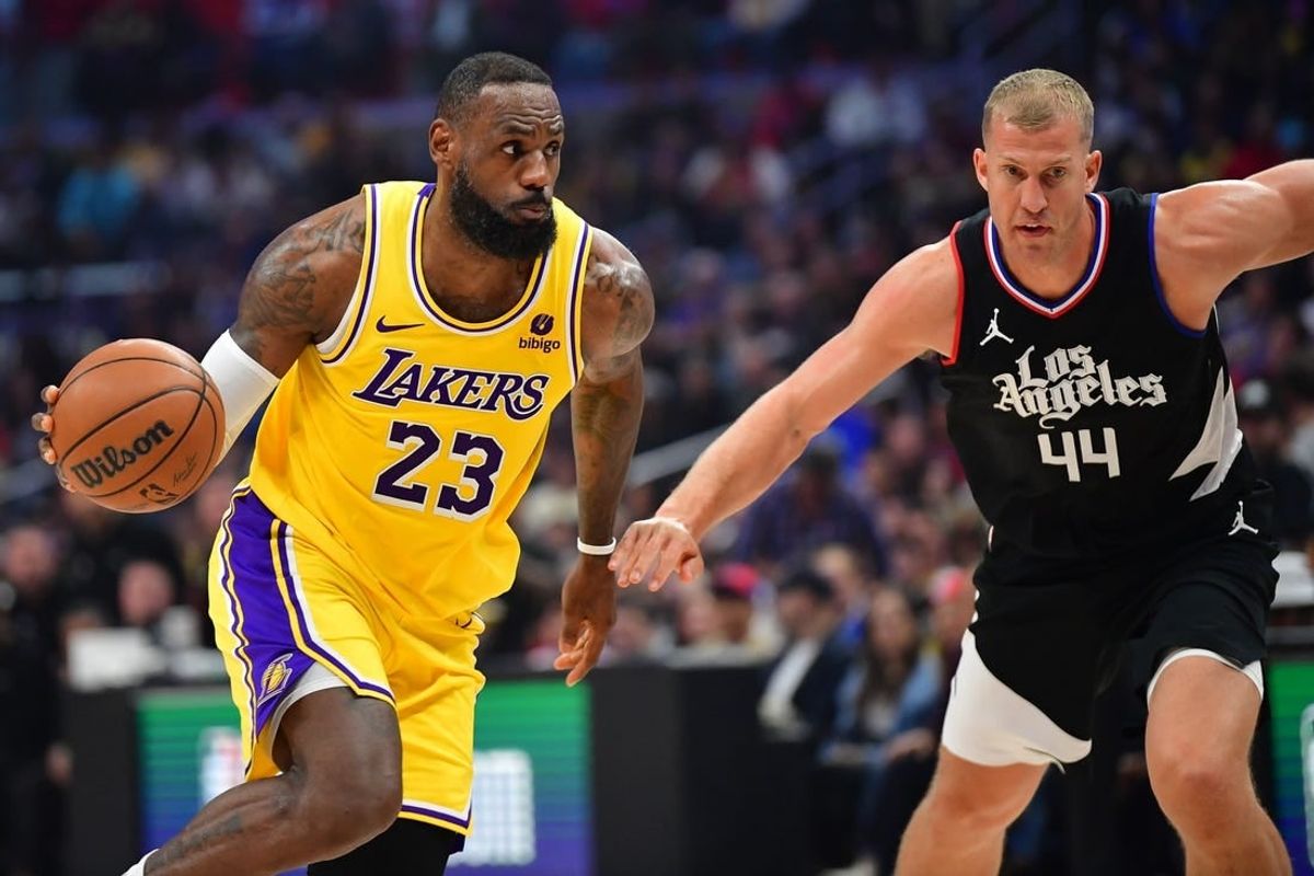 Feb 28, 2024; Los Angeles, California, USA; Los Angeles Lakers forward LeBron James (23) moves the ball against Los Angeles Clippers center Mason Plumlee (44) during the first half at Crypto.com Arena.