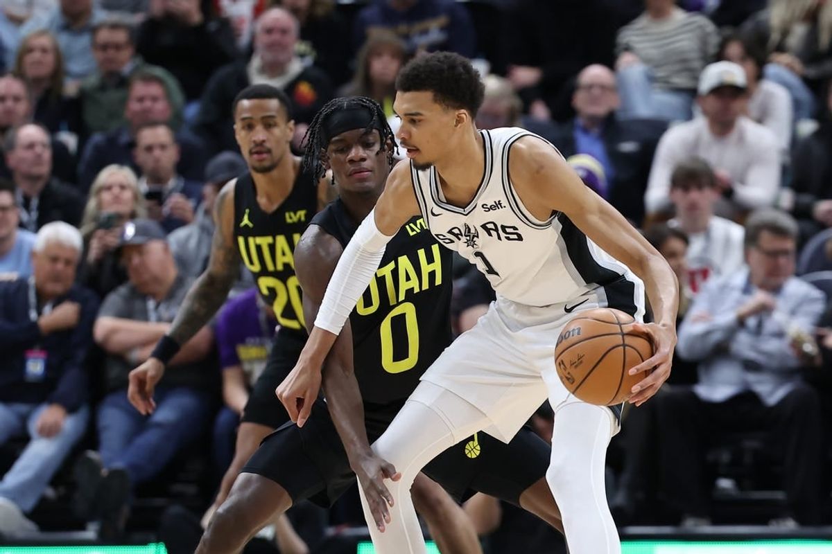 Mar 27, 2024; Salt Lake City, Utah, USA; San Antonio Spurs center Victor Wembanyama (1) moves the ball away from Utah Jazz forward Taylor Hendricks (0) during the second quarter at Delta Center.