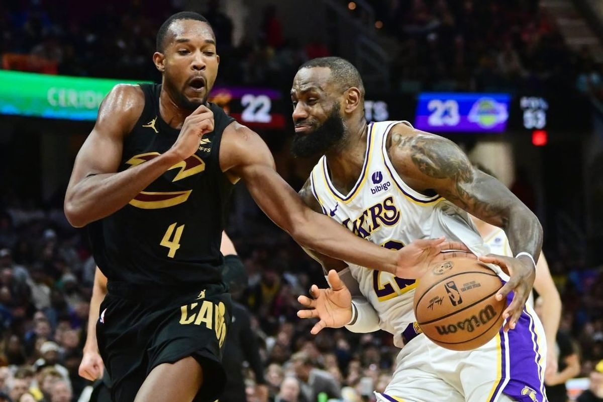 Nov 25, 2023; Cleveland, Ohio, USA; Cleveland Cavaliers forward Evan Mobley (4) fouls Los Angeles Lakers forward LeBron James (23) during the second half at Rocket Mortgage FieldHouse.
