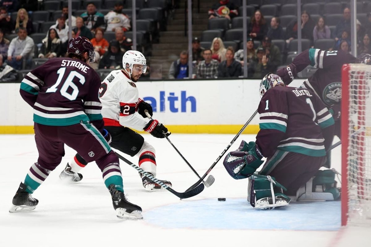 Mar 6, 2024; Anaheim, California, USA;  Ottawa Senators defenseman Artem Zub (2) fights for the puck against Anaheim Ducks goaltender Lukas Dostal (1) during the first period at Honda Center.