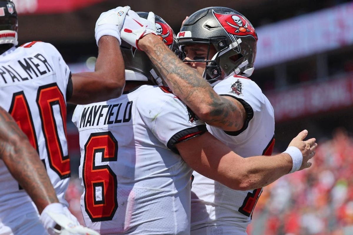 Sep 17, 2023; Tampa, Florida, USA; Tampa Bay Buccaneers wide receiver Mike Evans (13) is congratulated by quarterback Baker Mayfield (6) after scoring a touchdown against the Chicago Bears during the second half at Raymond James Stadium.
