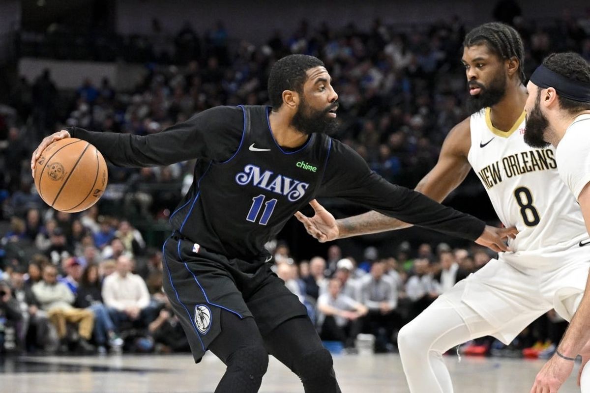 Jan 15, 2024; Dallas, Texas, USA; Dallas Mavericks guard Kyrie Irving (11) looks to move the ball past New Orleans Pelicans forward Naji Marshall (8) during the second quarter at the American Airlines Center.