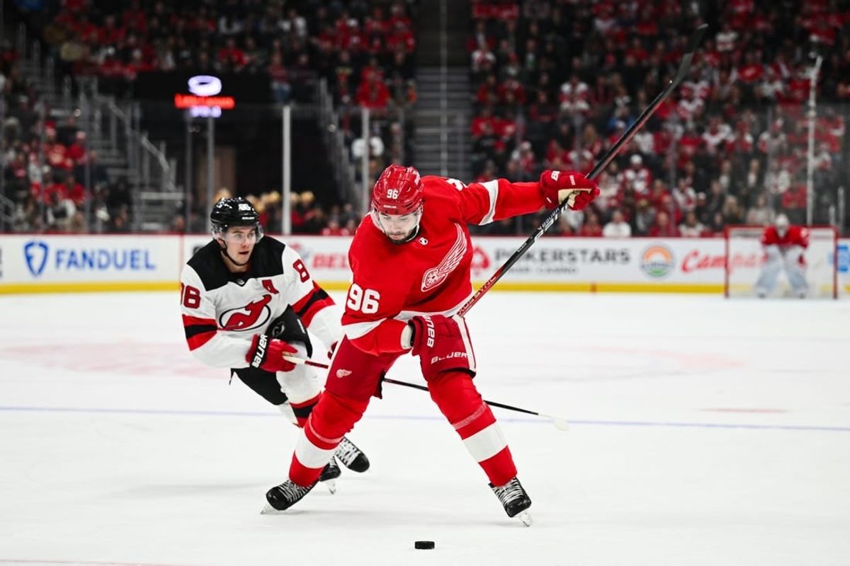 Nov 22, 2023; Detroit, Michigan, USA; Detroit Red Wings defenseman Jake Walman (96) shoots as New Jersey New Jersey Devils center Jack Hughes (86) attempts to defend during the second period at Little Caesars Arena.
